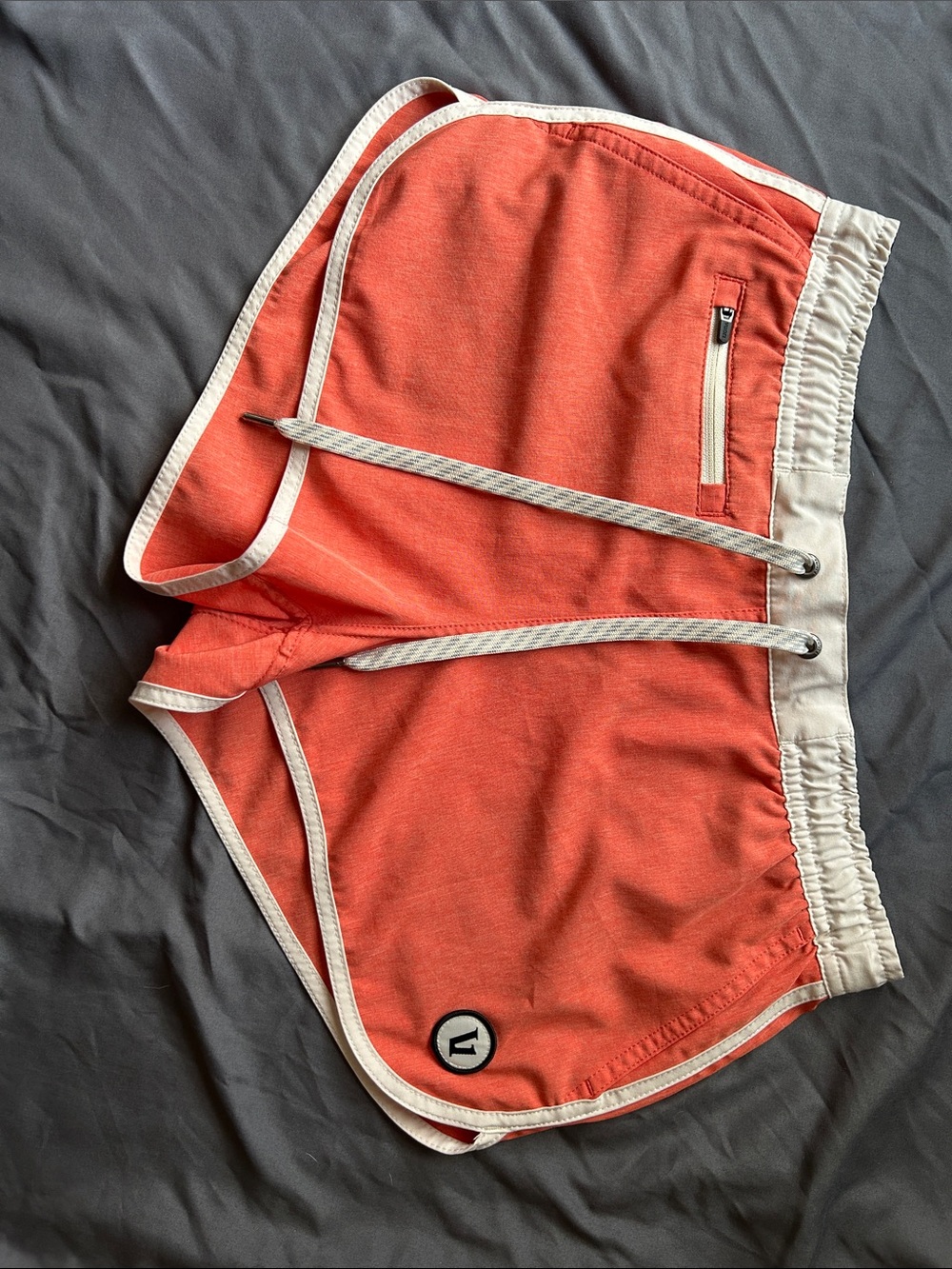 Vuori Coral-Orange Athletic Shorts with Cream Trim